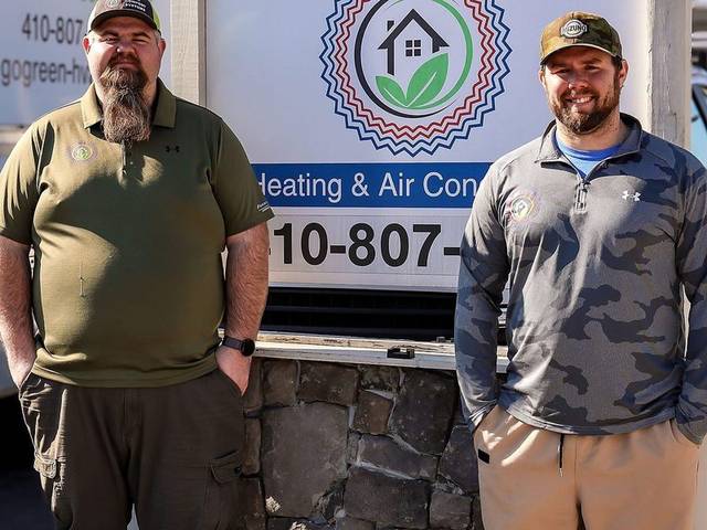 Two Green Comfort Systems team members outside the company's Rosedale shop